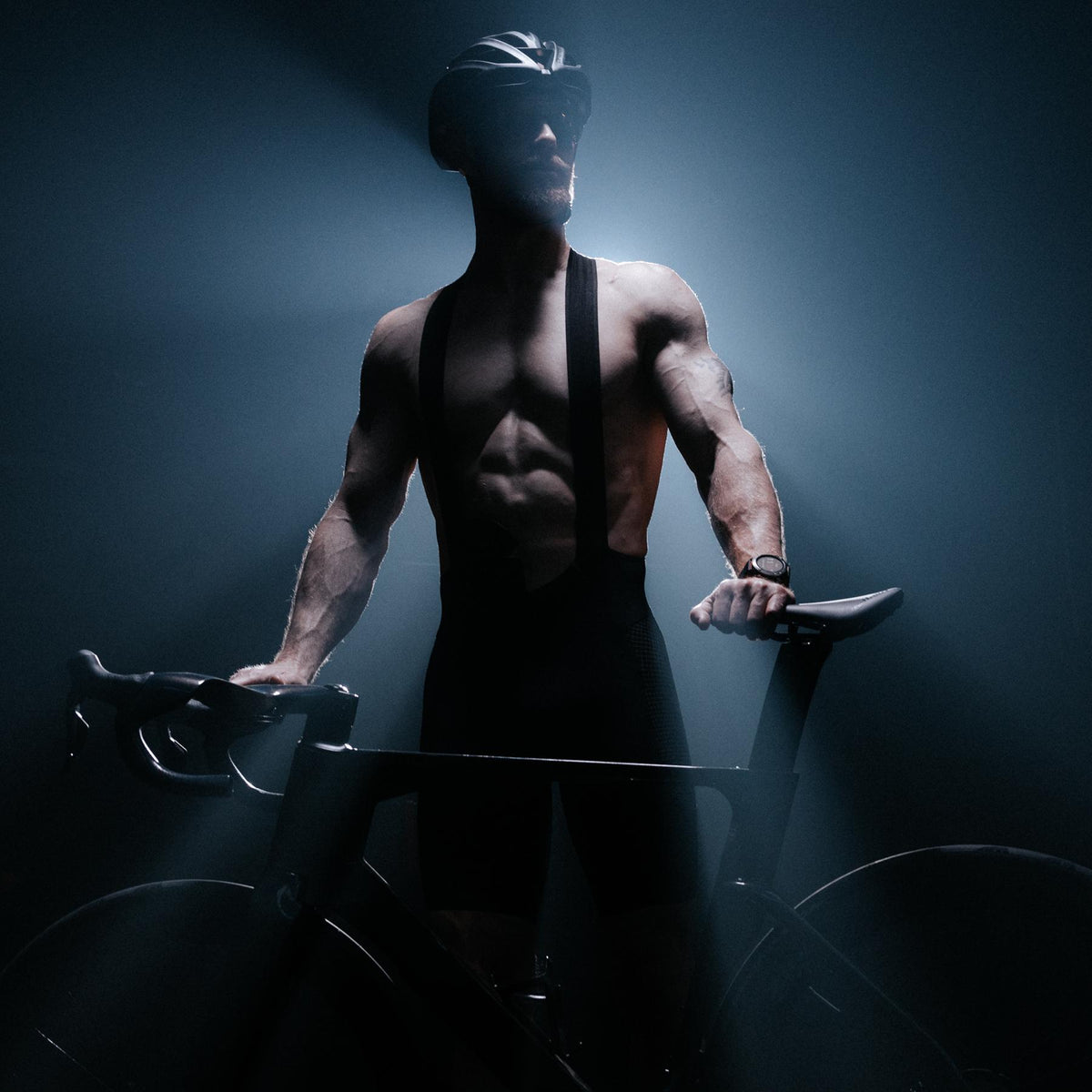 A creative studio shot of Men's Force Cadence Road Bib Shorts in Obsidian Black (CS)