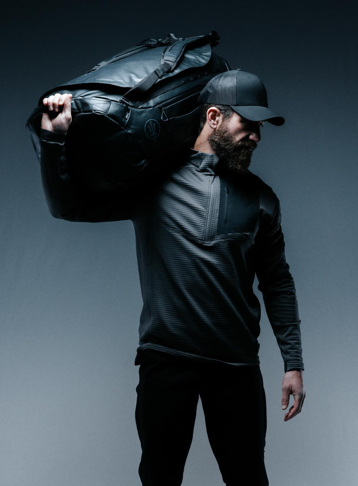 A creative studio shot of Citadel 80L Duffel Bag in Obsidian Black (CS)