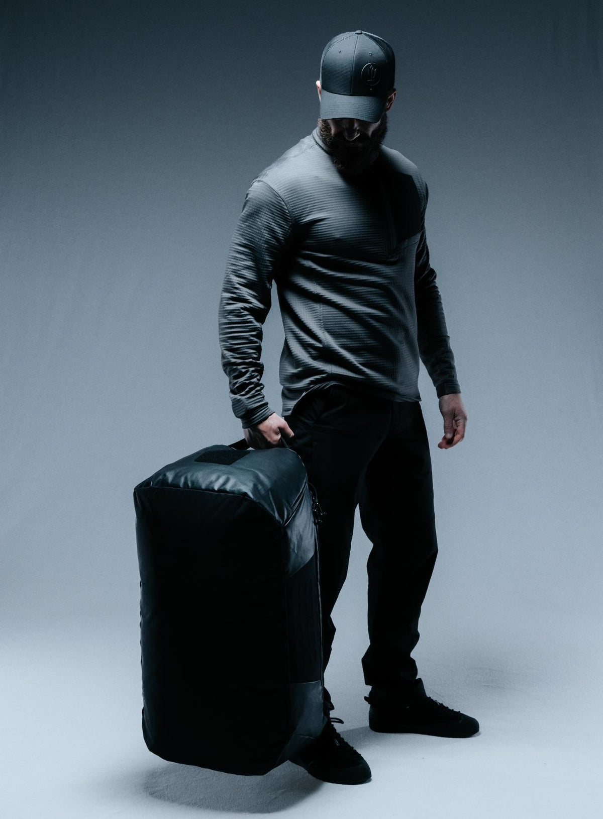 A creative studio shot of Citadel 80L Duffel Bag in Obsidian Black (CS)