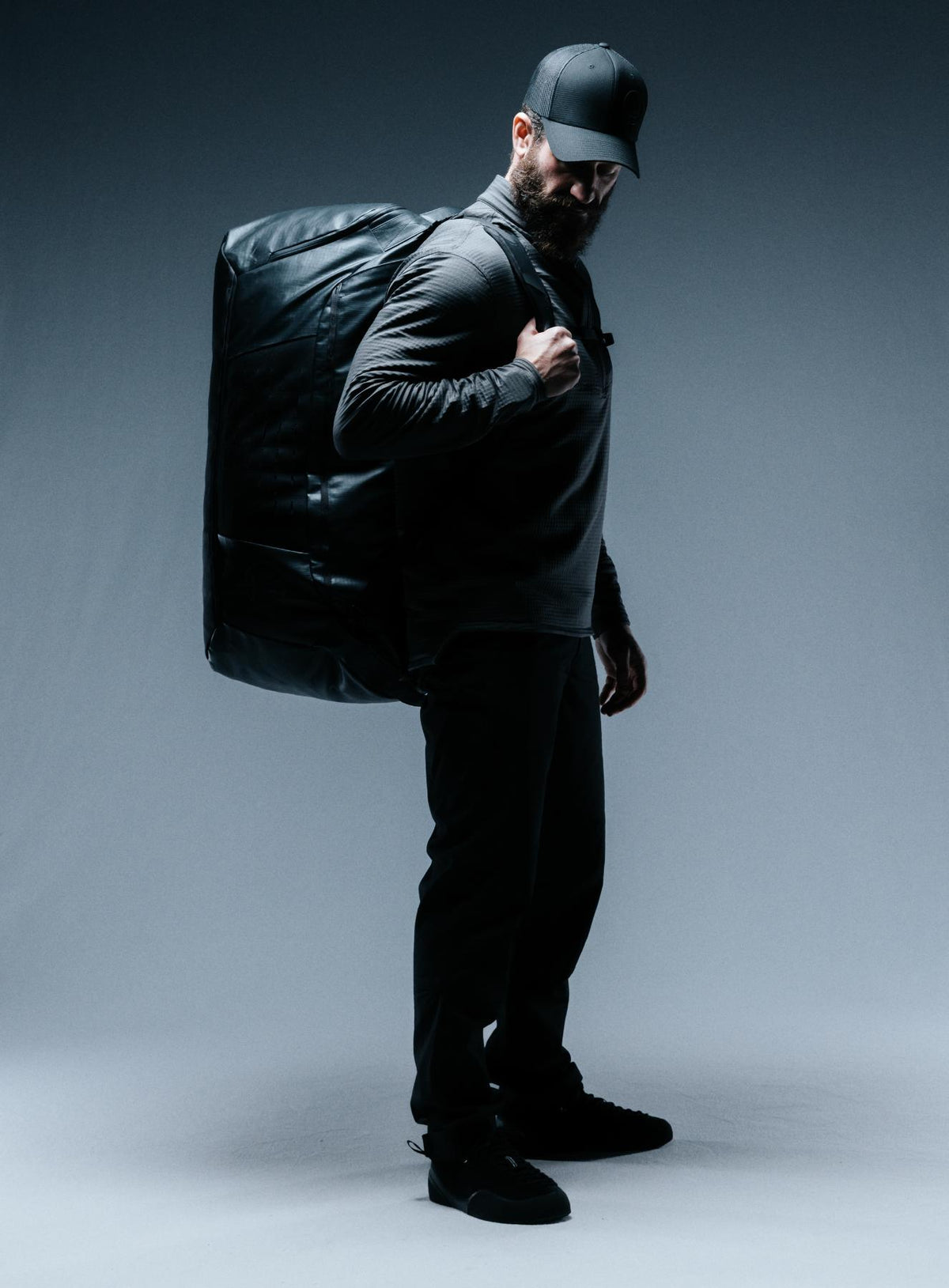 A creative studio shot of Citadel 80L Duffel Bag in Obsidian Black (CS)