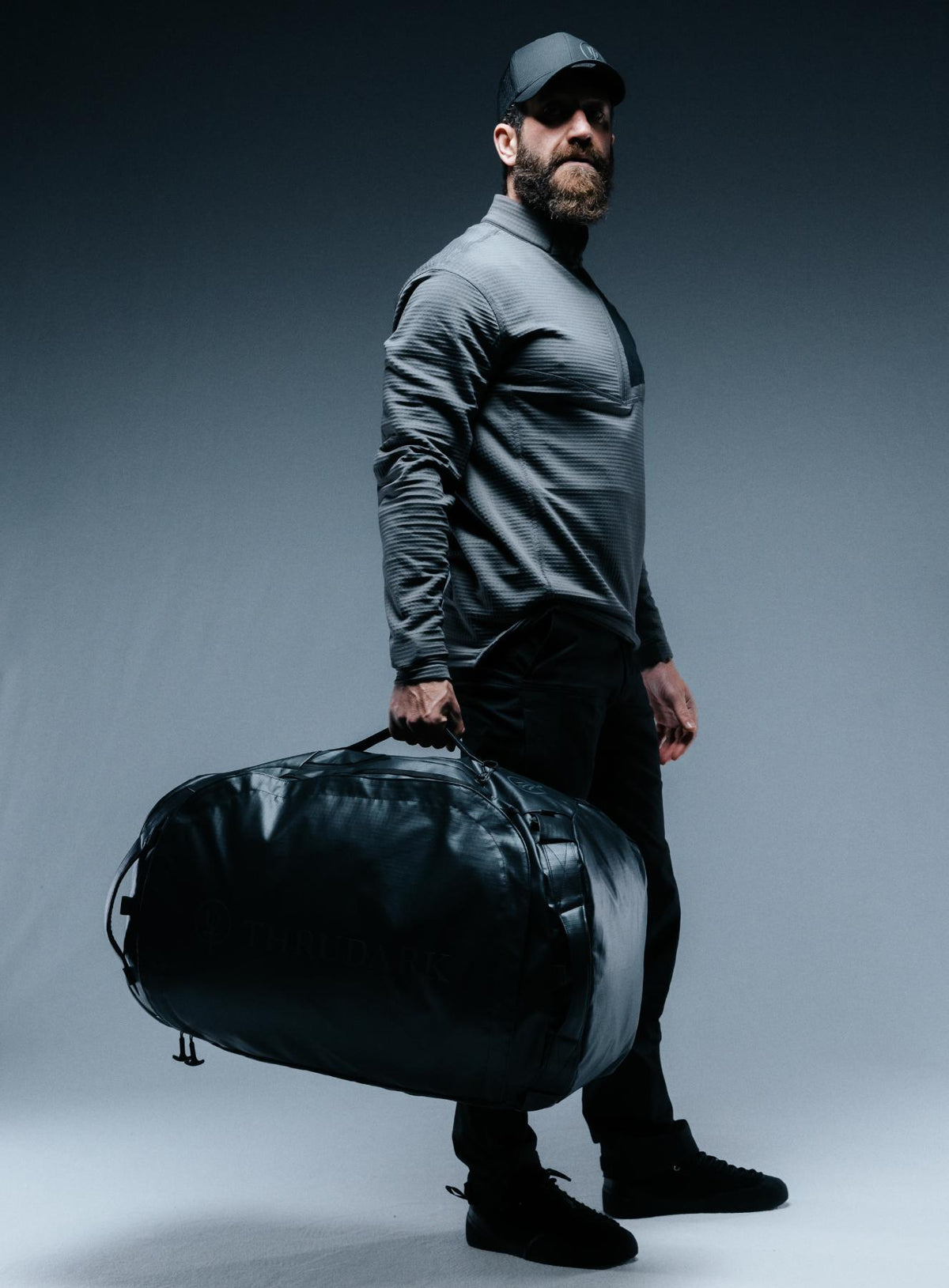 A creative studio shot of Citadel 80L Duffel Bag in Obsidian Black (CS)