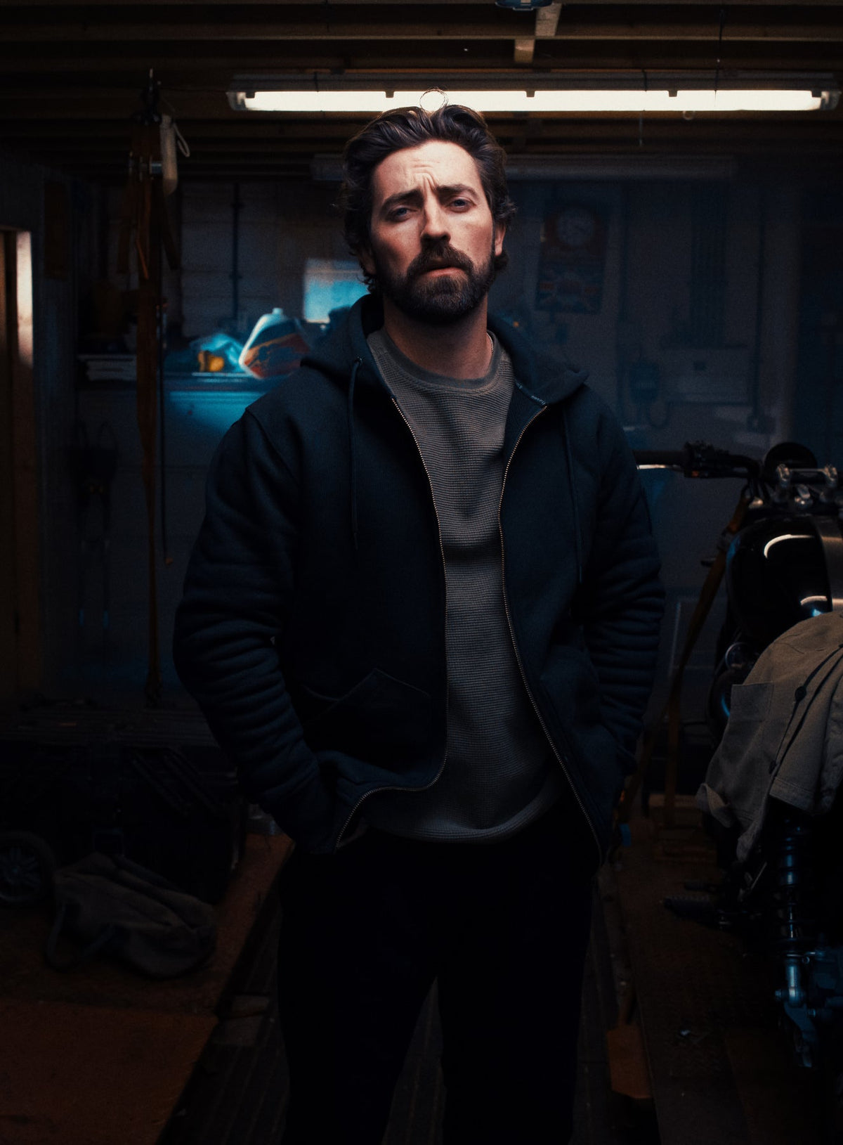 An in the field image of Men's Dissident Zipped Hoodie in Obsidian Black (ITF)