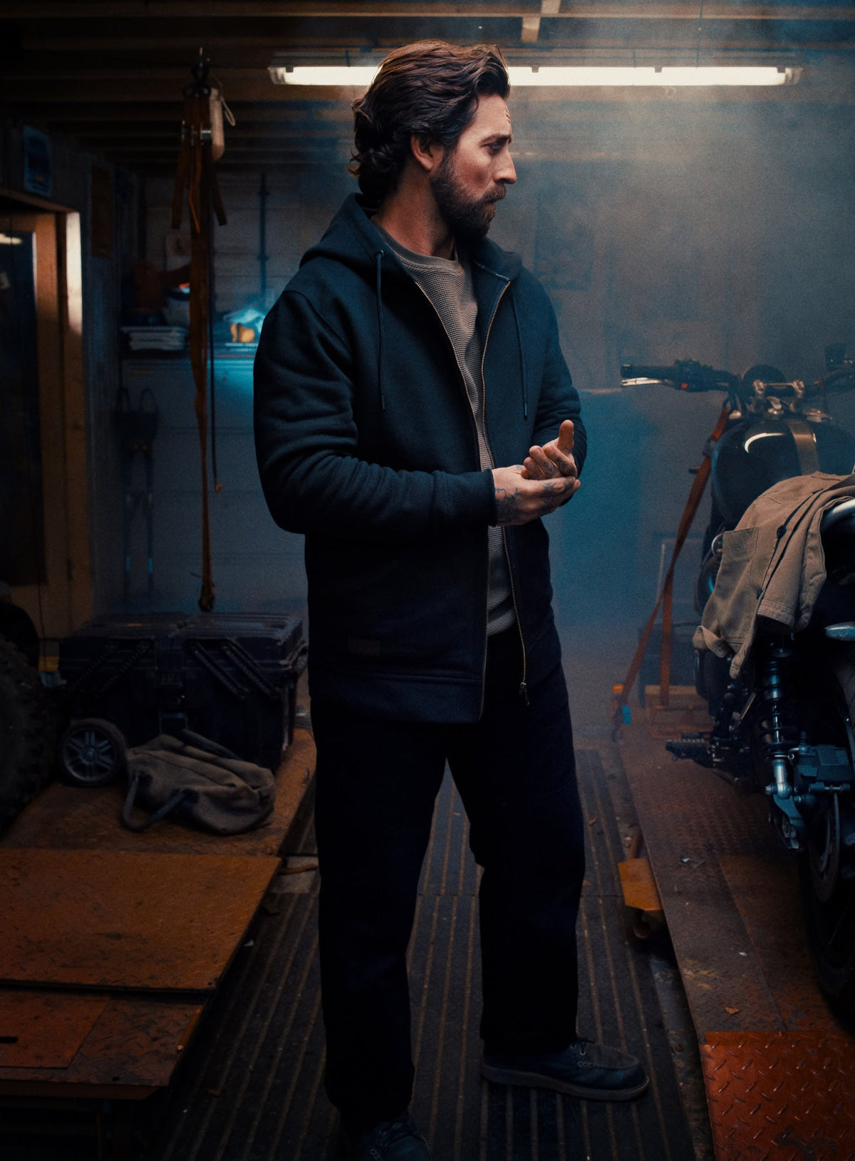 An in the field image of Men's Dissident Zipped Hoodie in Obsidian Black (ITF)
