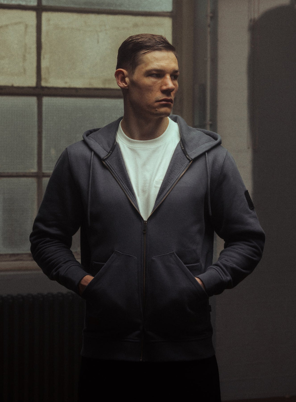 An in the field image of Men's Dissident Zipped Hoodie in Storm Blue (ITF)