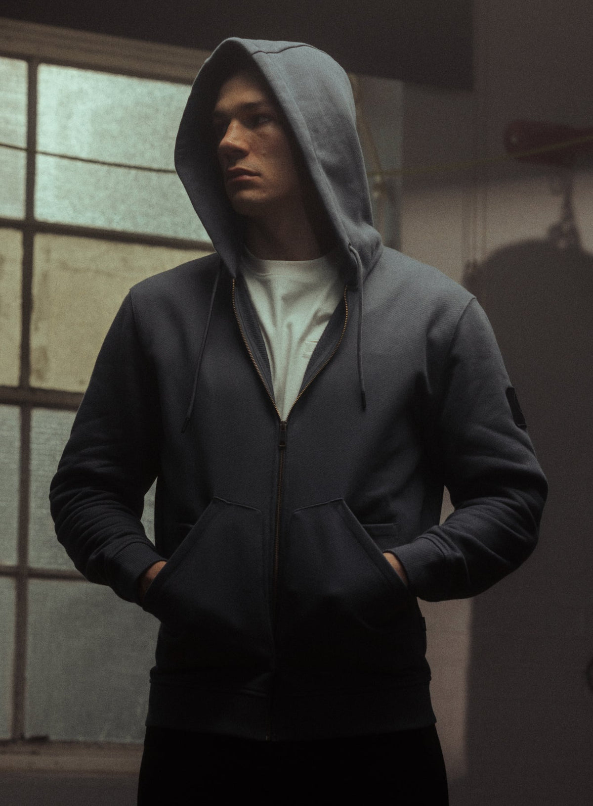 An in the field image of Men's Dissident Zipped Hoodie in Storm Blue (ITF)
