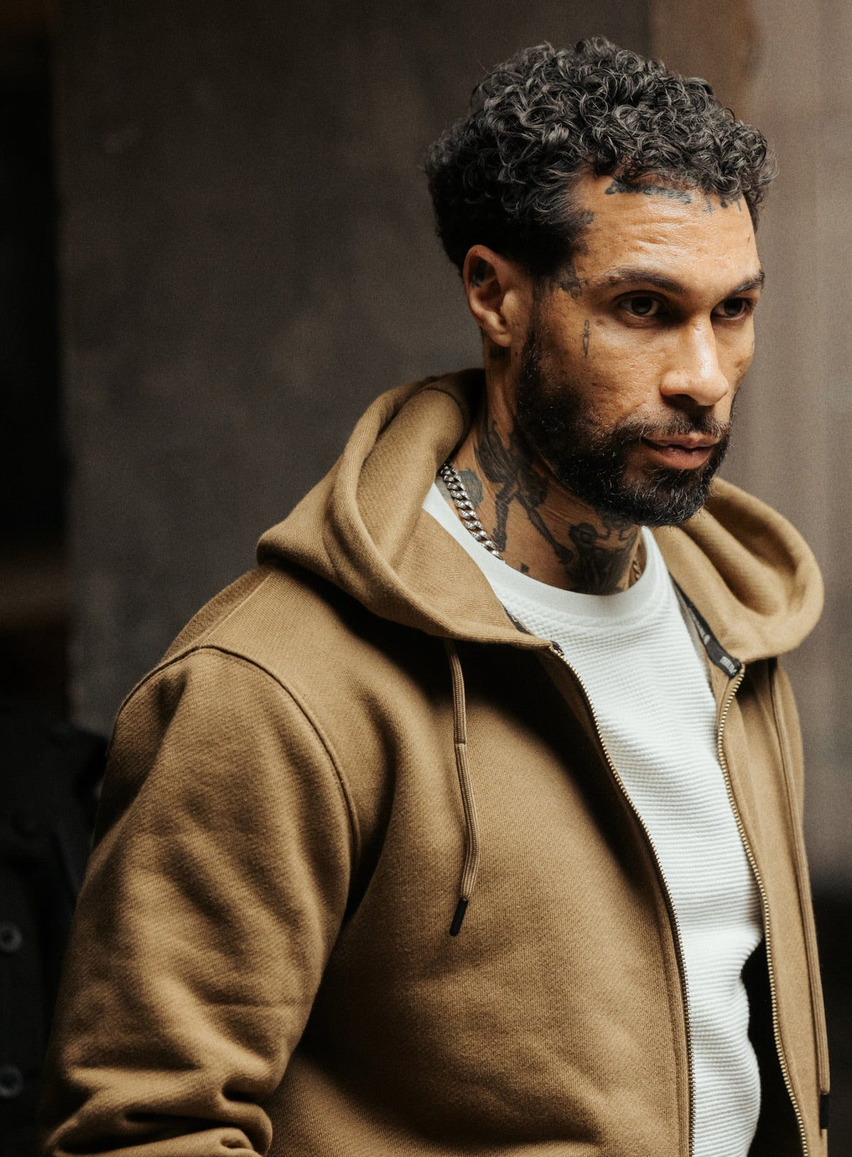 An in the field image of Men's Dissident Zipped Hoodie in Coyote Brown (ITF)