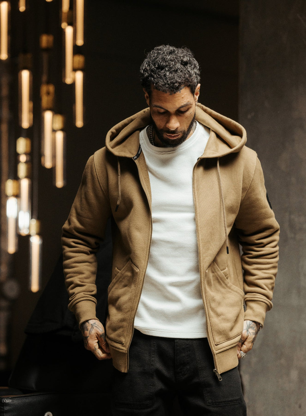 An in the field image of Men's Dissident Zipped Hoodie in Coyote Brown (ITF)