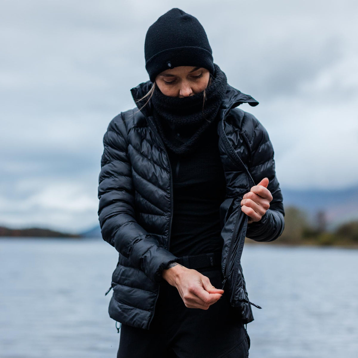 An in the field image of Women's Ithax Funnel Jacket in Obsidian Black (ITF)