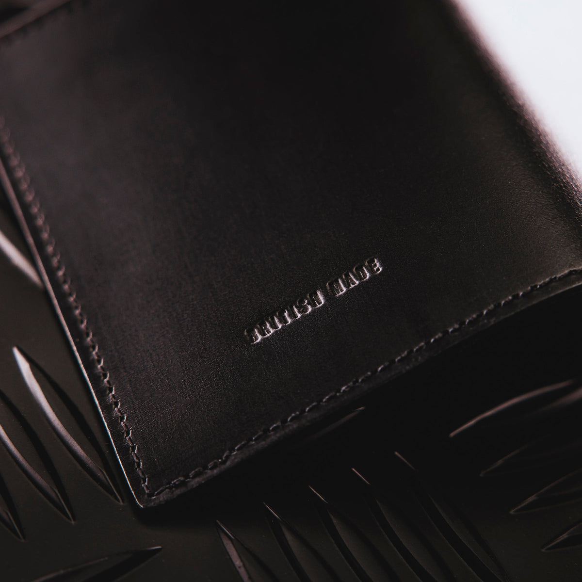A creative studio shot of Leather Bi Fold Wallet in Black (CS)
