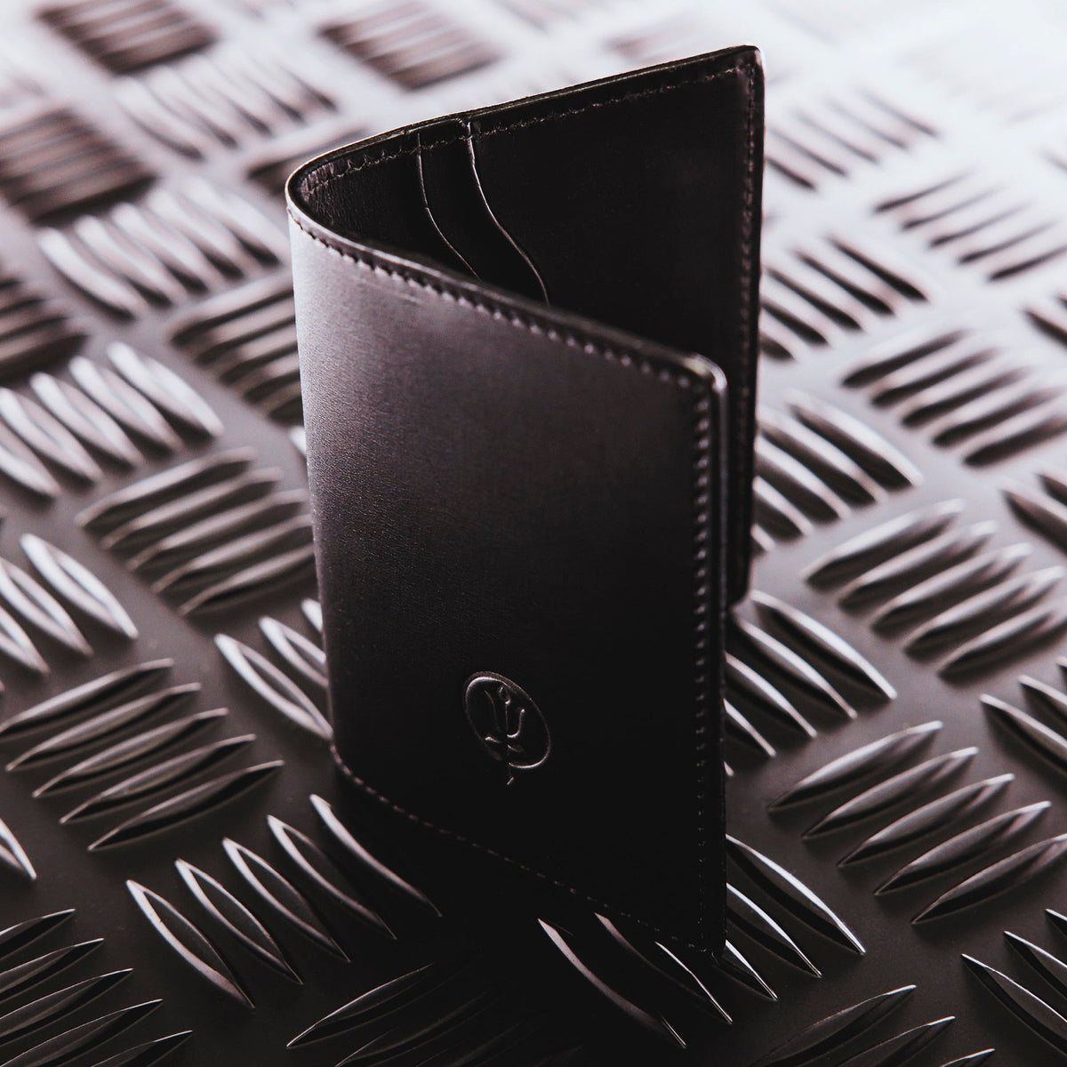 A creative studio shot of Leather Bi Fold Wallet in Black (CS)