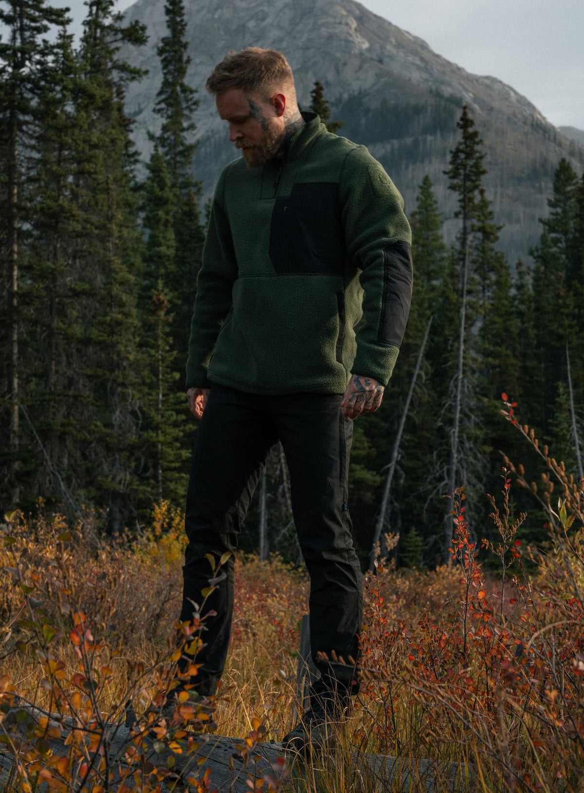 An in the field image of Men's Mantra Fleece 1/4 Zip in Forest Green (ITF)
