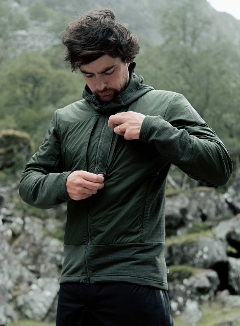An in the field image of Men's Mountain Pro Fusion Jacket in Forest Green (ITF)