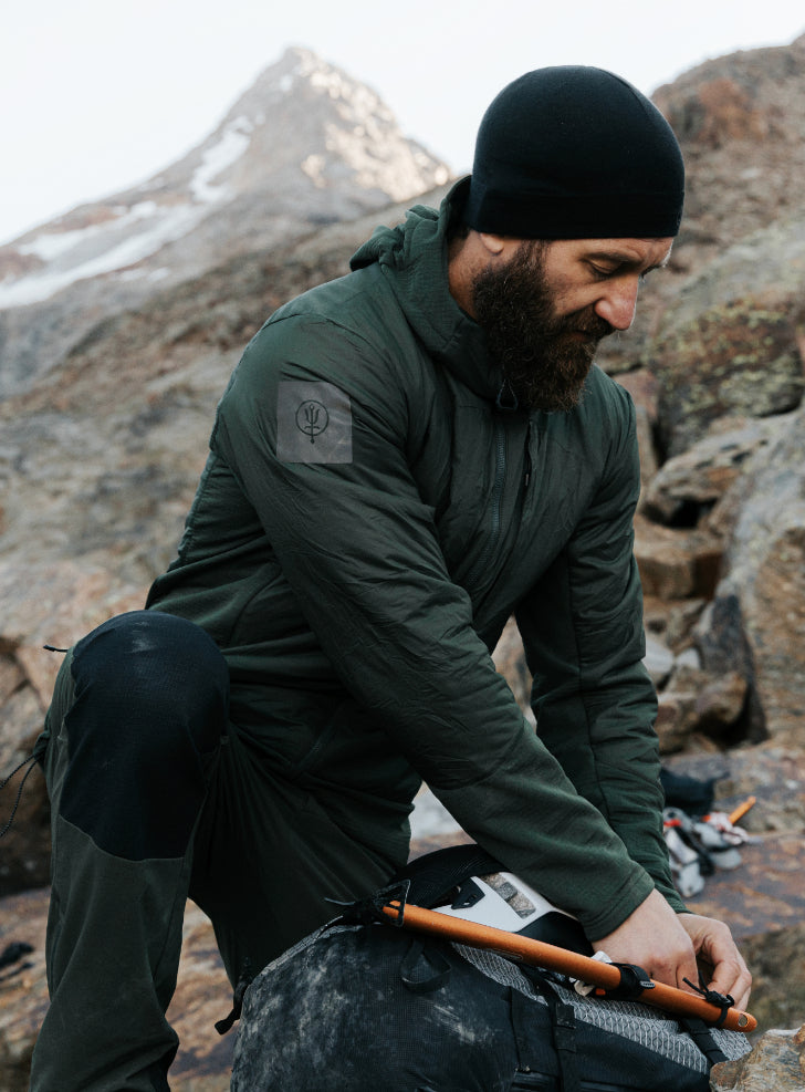An in the field image of Men's Mountain Pro Fusion Jacket in Forest Green (ITF)