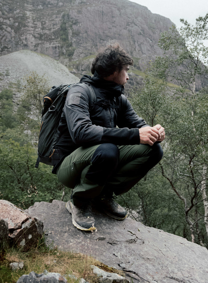 An in the field image of Men's Mountain Pro Fusion Jacket in Obsidian Black (ITF)