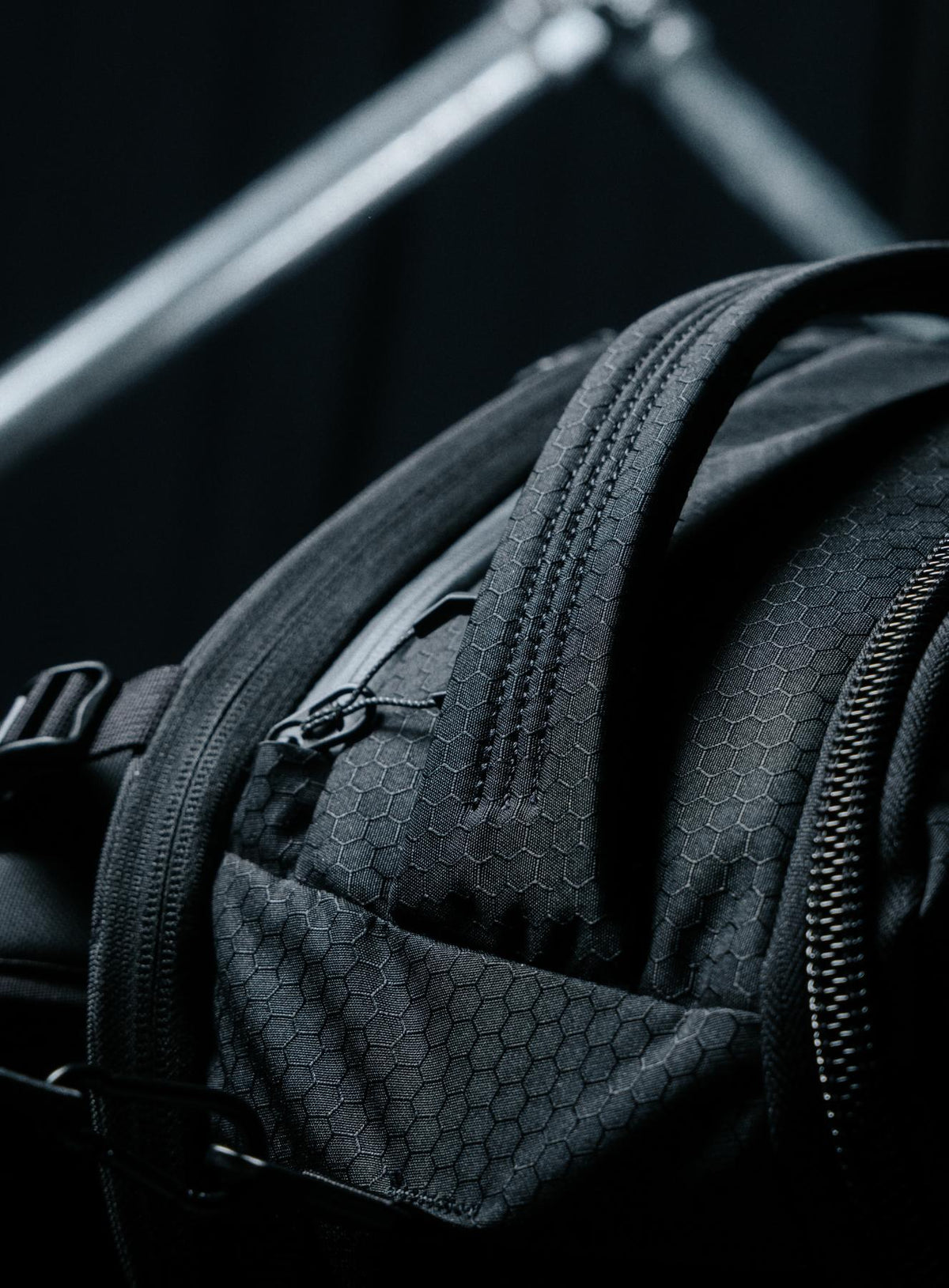 A creative studio shot of Phantom 40L Backpack in Obsidian Black (CS)