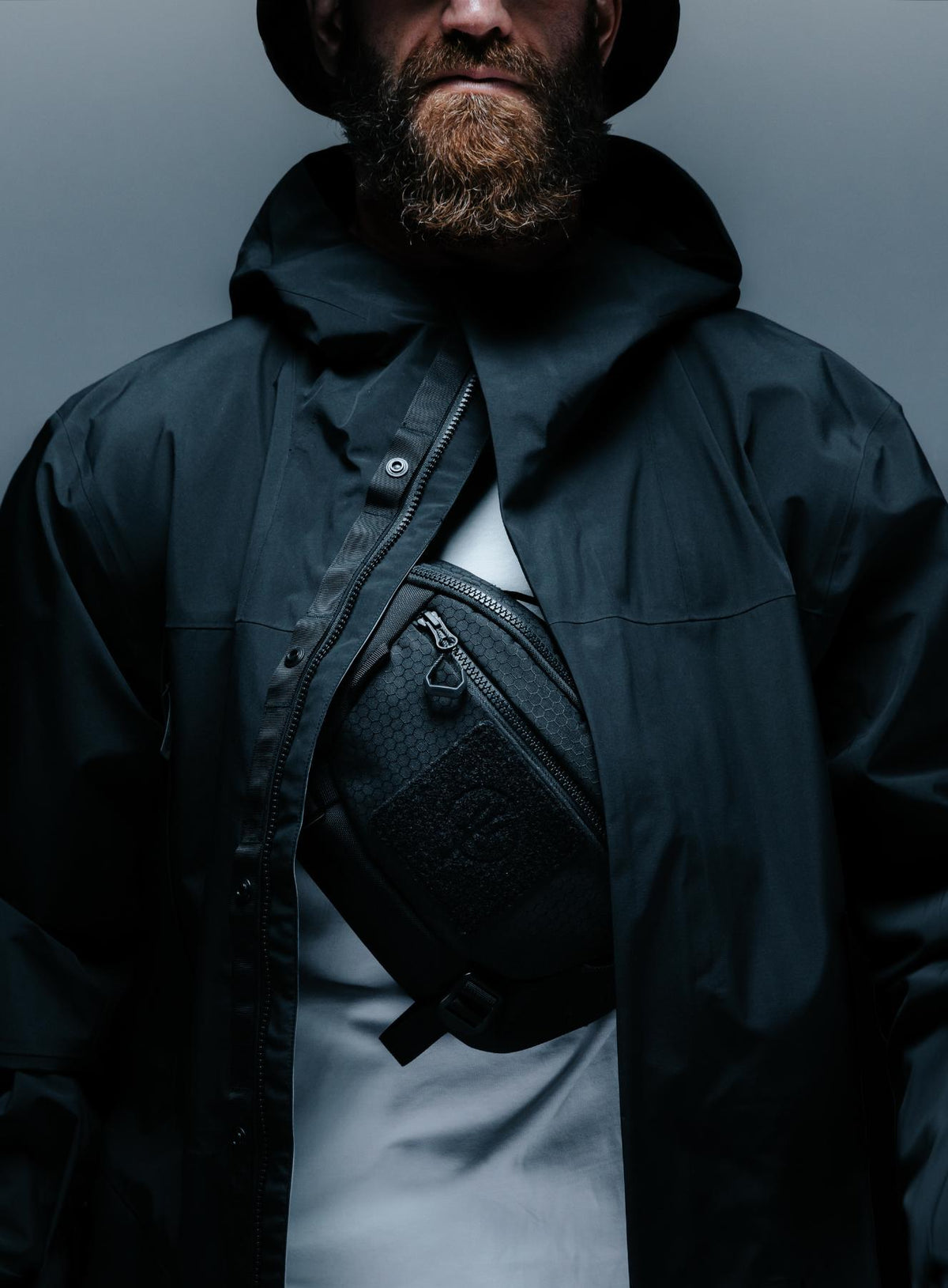 A creative studio shot of Spectral 5L Waist Pack in Obsidian Black (CS)