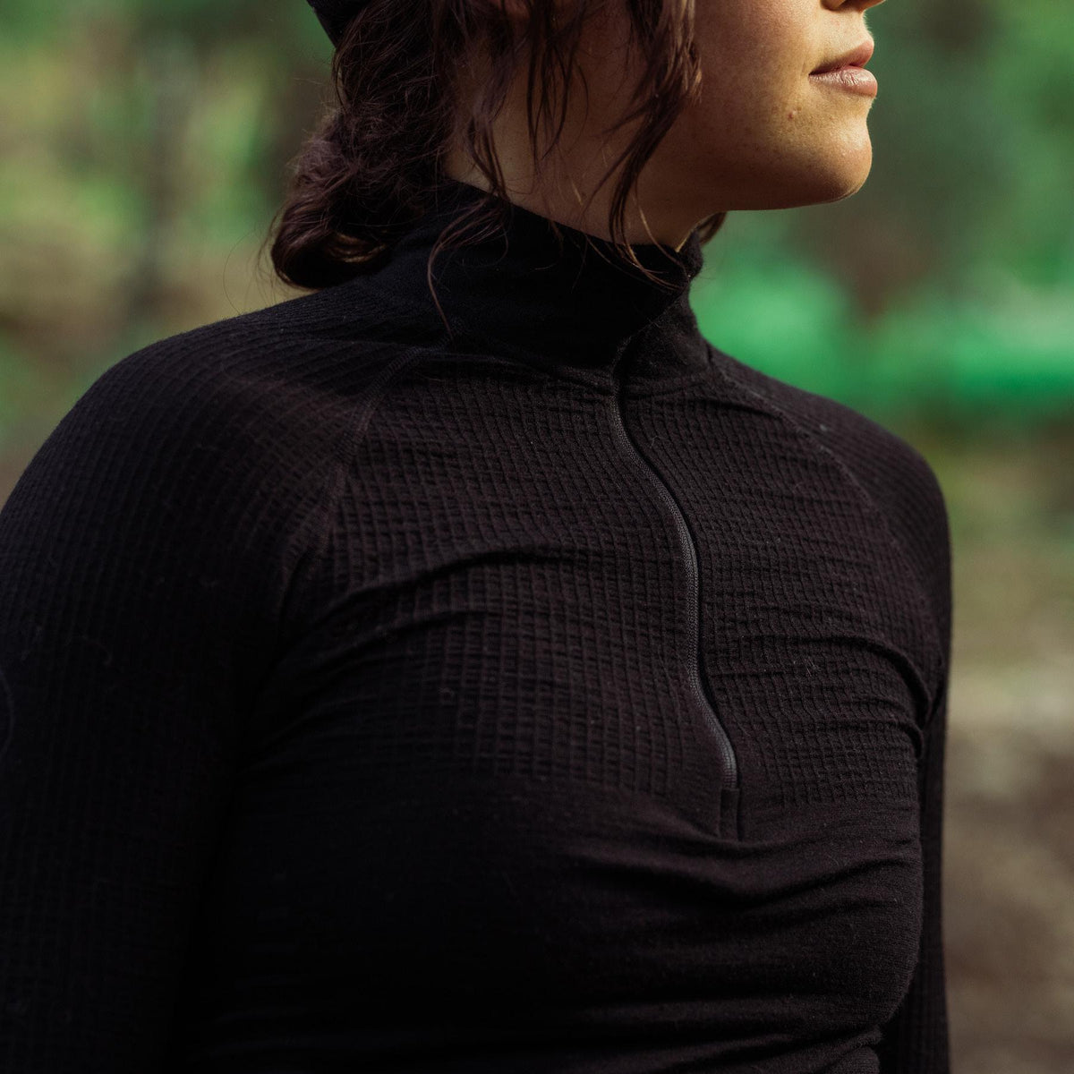 A creative studio shot of Women's Stealth Seamless Base Layer Top in Obsidian Black (CS)