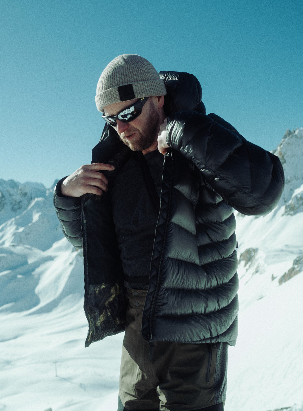 An in the field image of Men's Bastion Down Jacket in Obsidian Black (ITF)