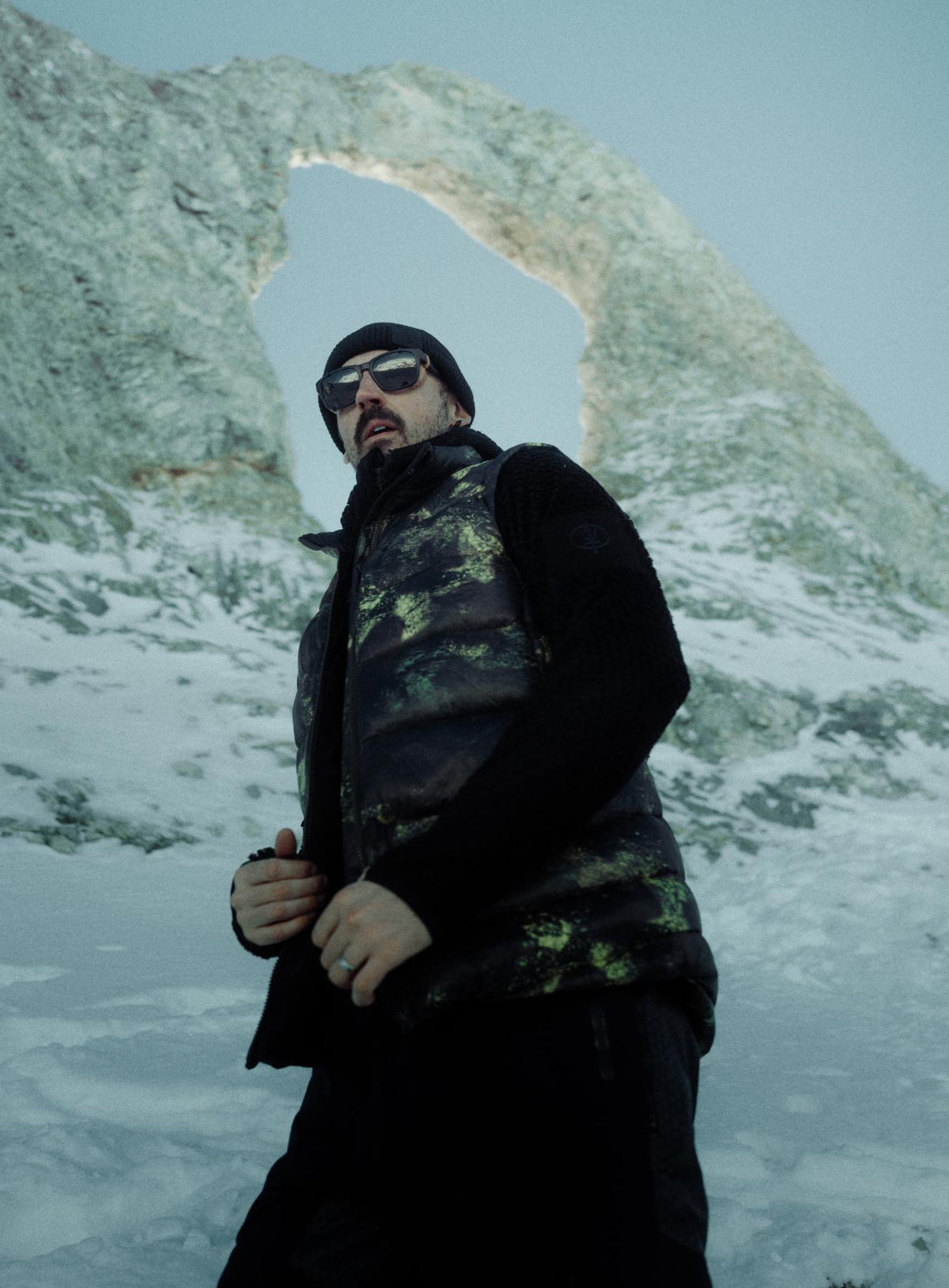 An in the field image of Men's Bastion Down Gilet in Temperate Camo (ITF)