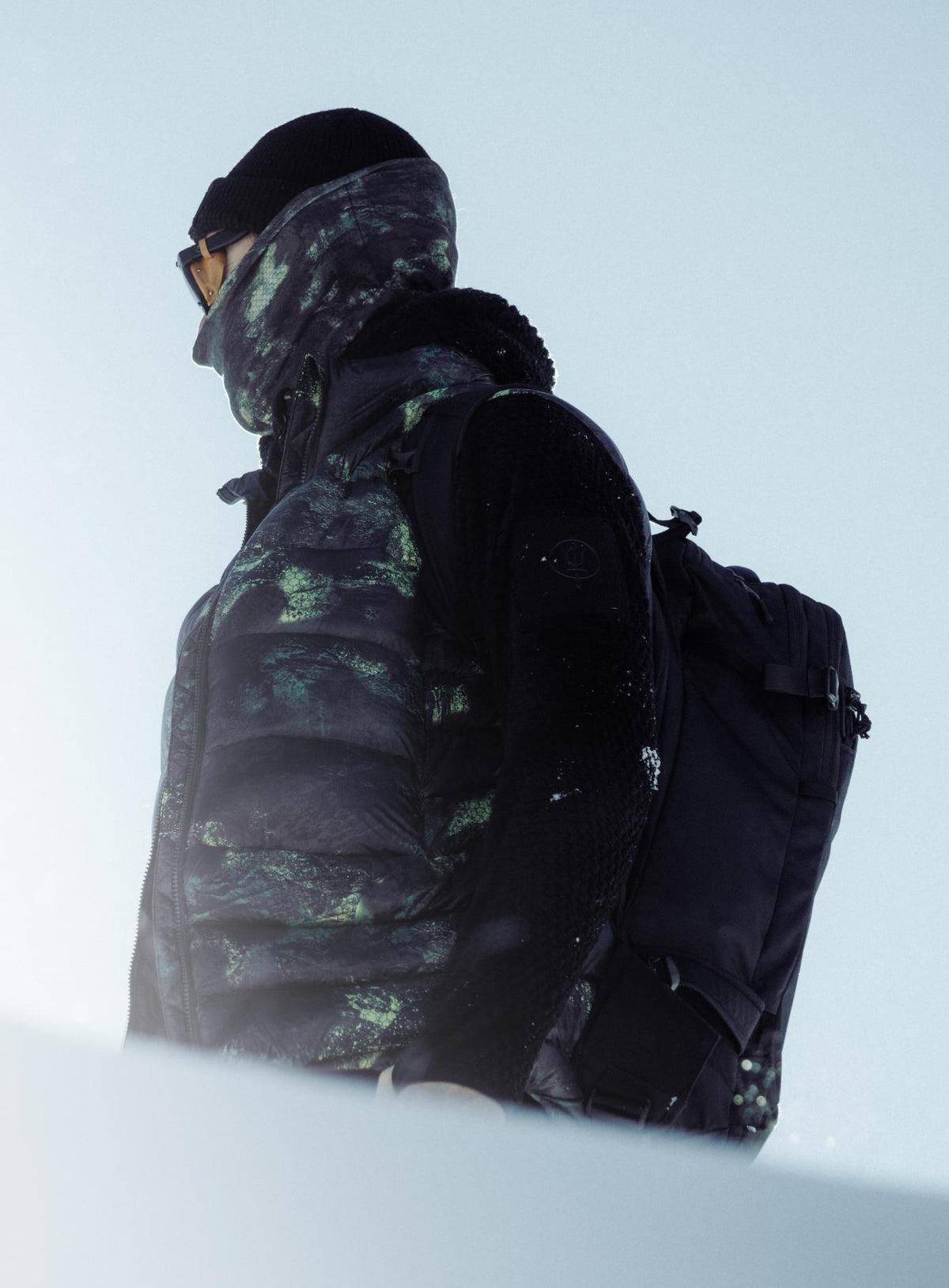 An in the field image of Men's Bastion Down Gilet in Temperate Camo (ITF)
