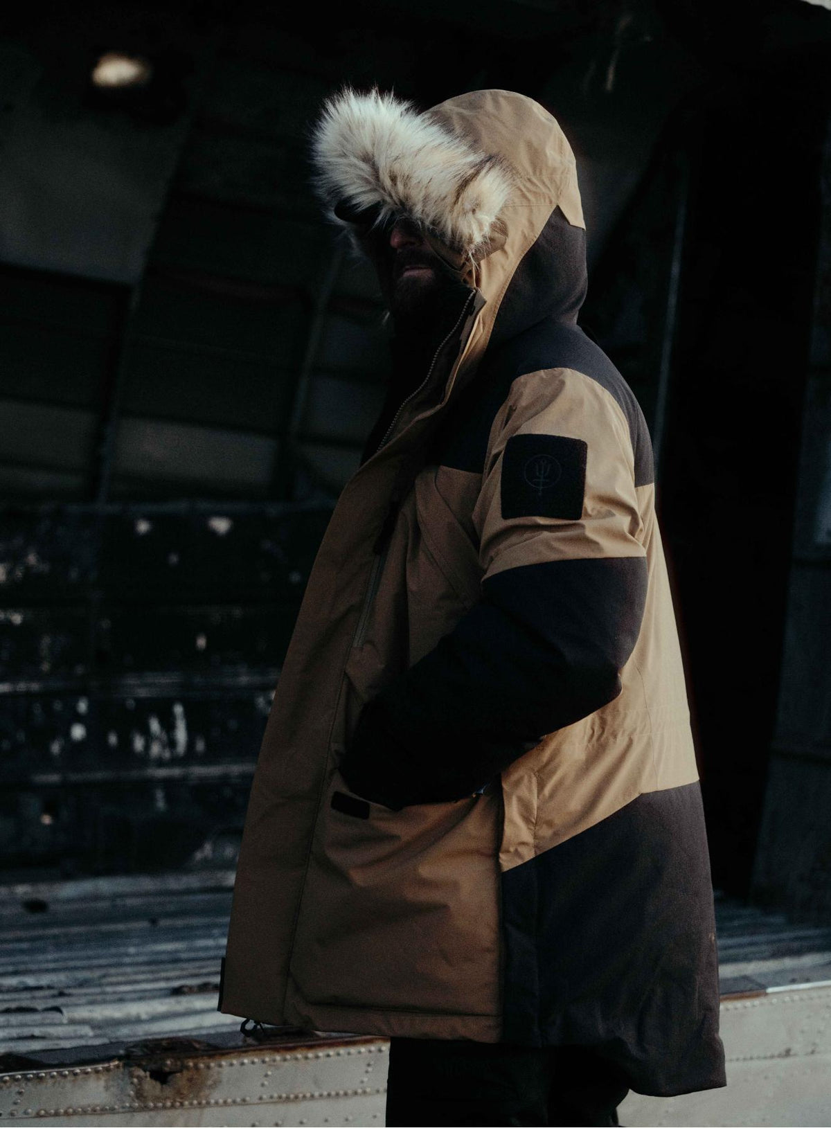 An in the field image of Men's End of Days Parka in Coyote Brown (ITF)