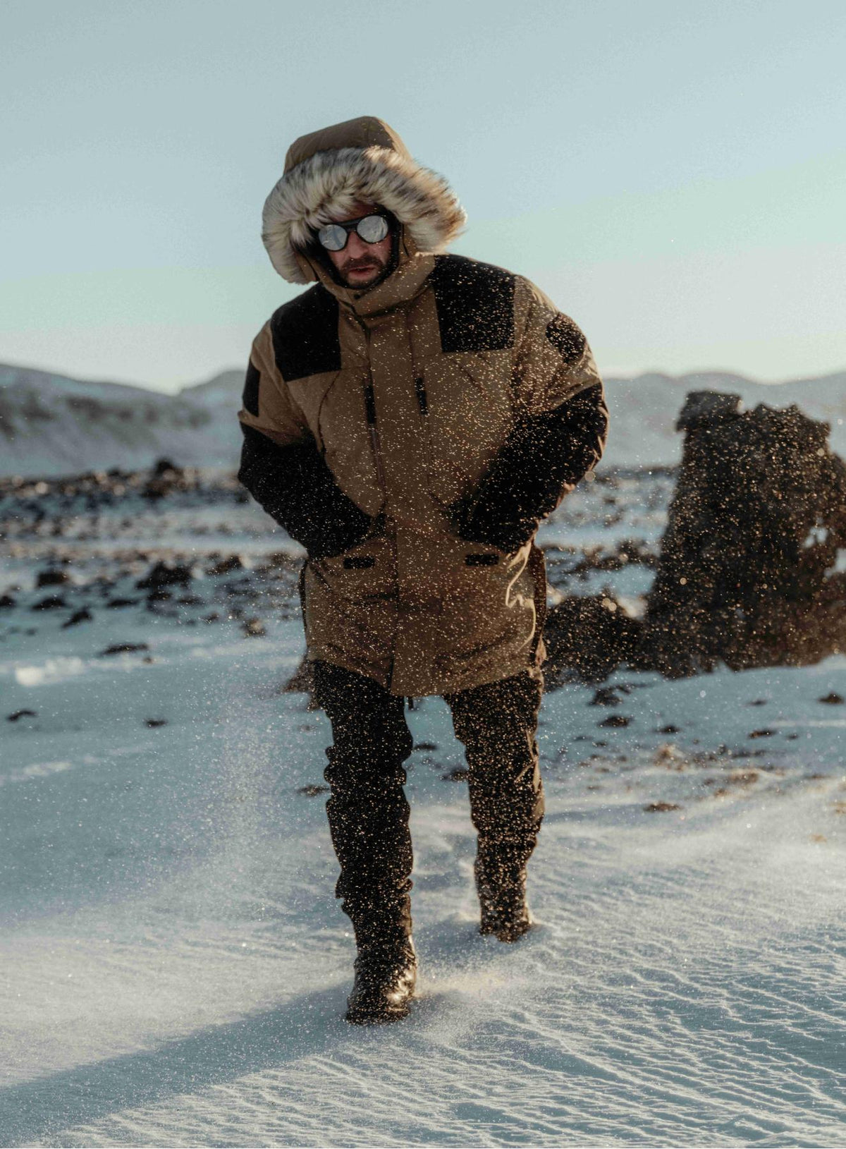 An in the field image of Men's End of Days Parka in Coyote Brown (ITF)