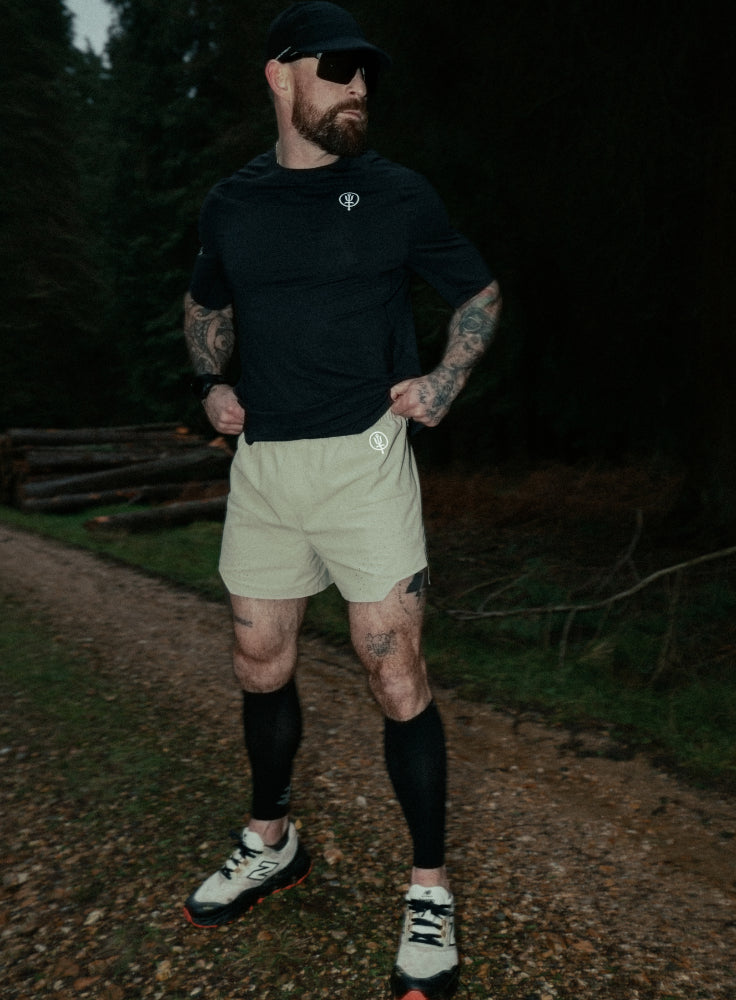 An in the field image of Force Trail Running 4” Shorts in Stone (ITF)