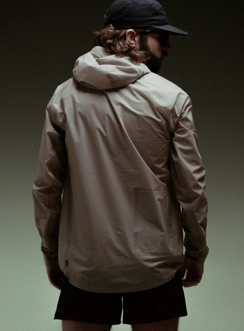 A creative studio shot of Force Trail Running Jacket in Stone (CS)
