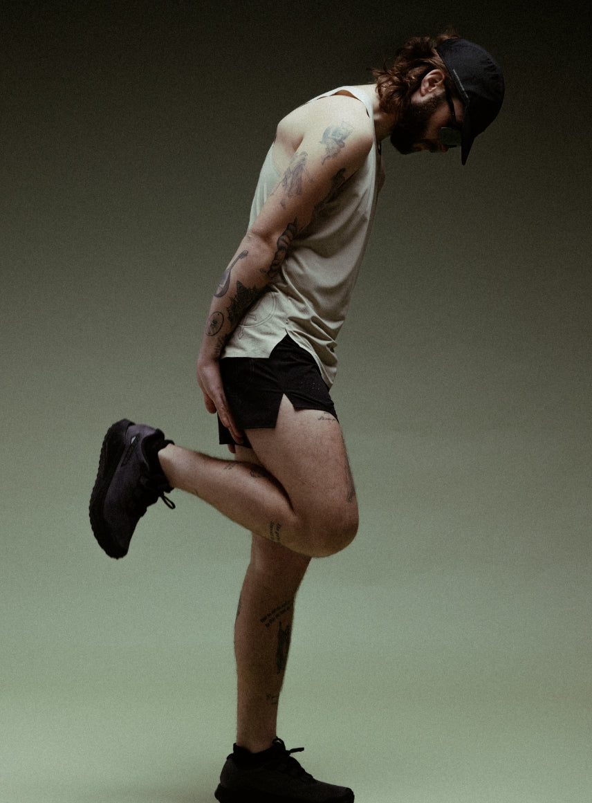 A creative studio shot of Force Trail Running Singlet in Stone (CS)