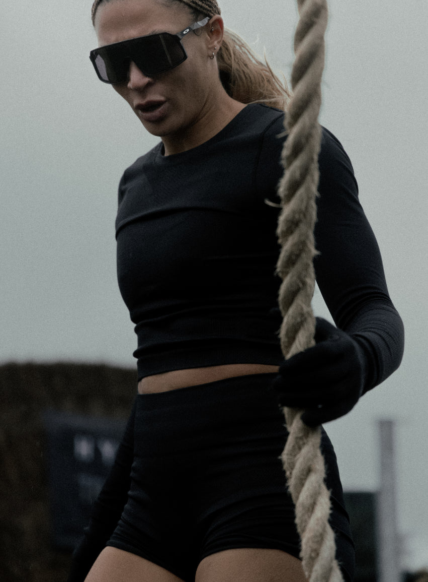 An in the field image of Women's Force Seamless Long Sleeve Top in Obsidian Black (ITF)