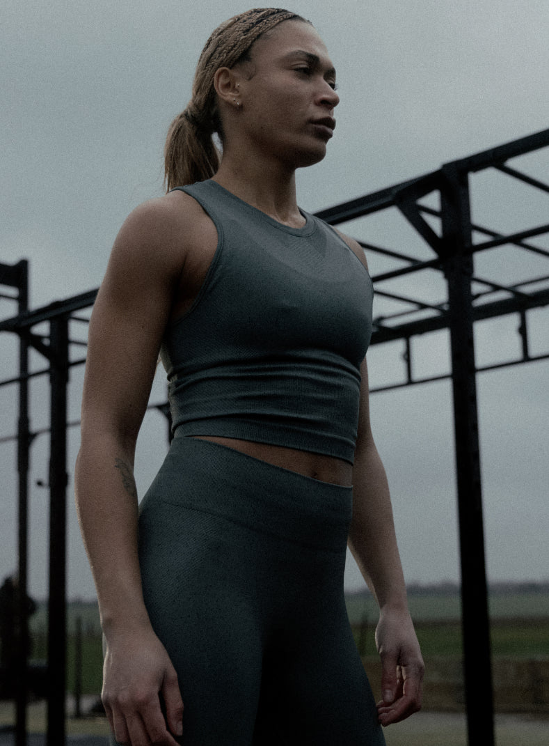 An in the field image of Women's Force Seamless Tank Top in Urban Green (ITF)