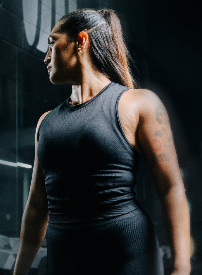 A creative studio shot of Women's Force Seamless Tank Top in Obsidian Black (CS)