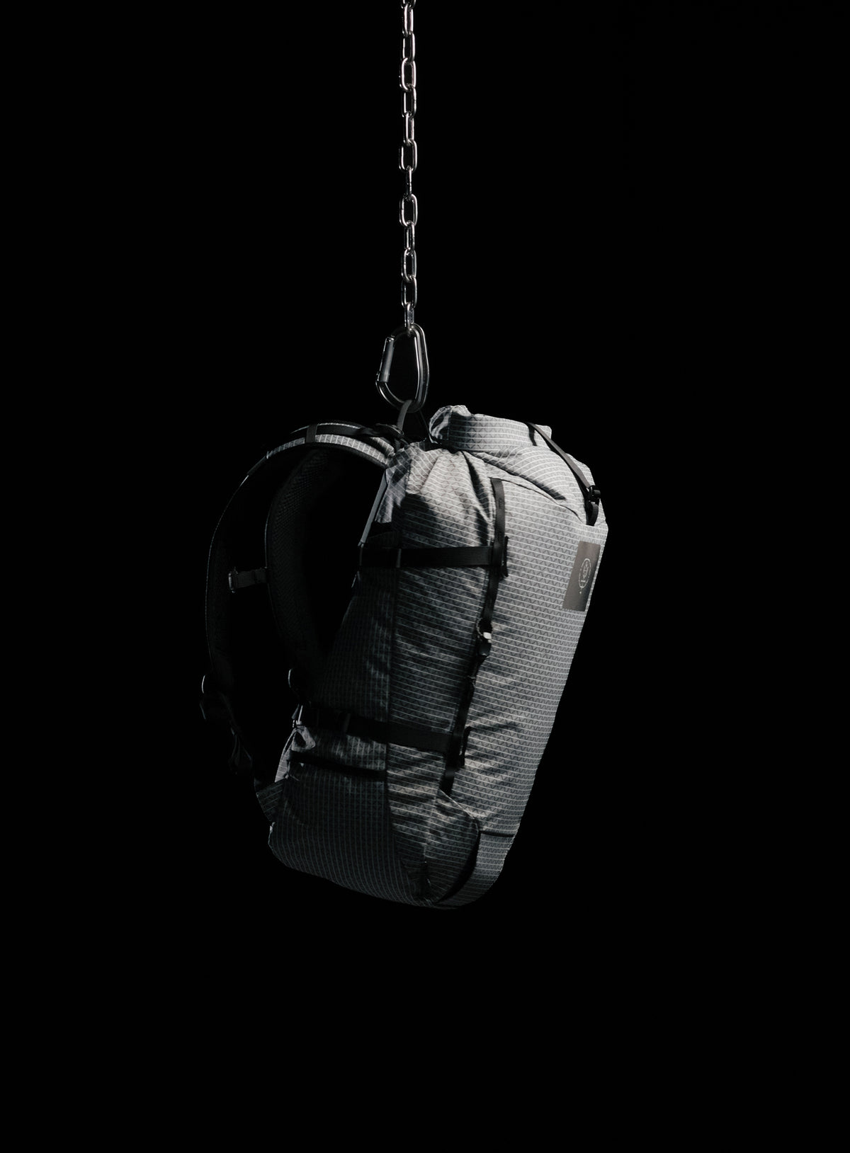 A creative studio shot of Orbital 30L Dyneema Climbing Backpack in Antimony Grey (CS)