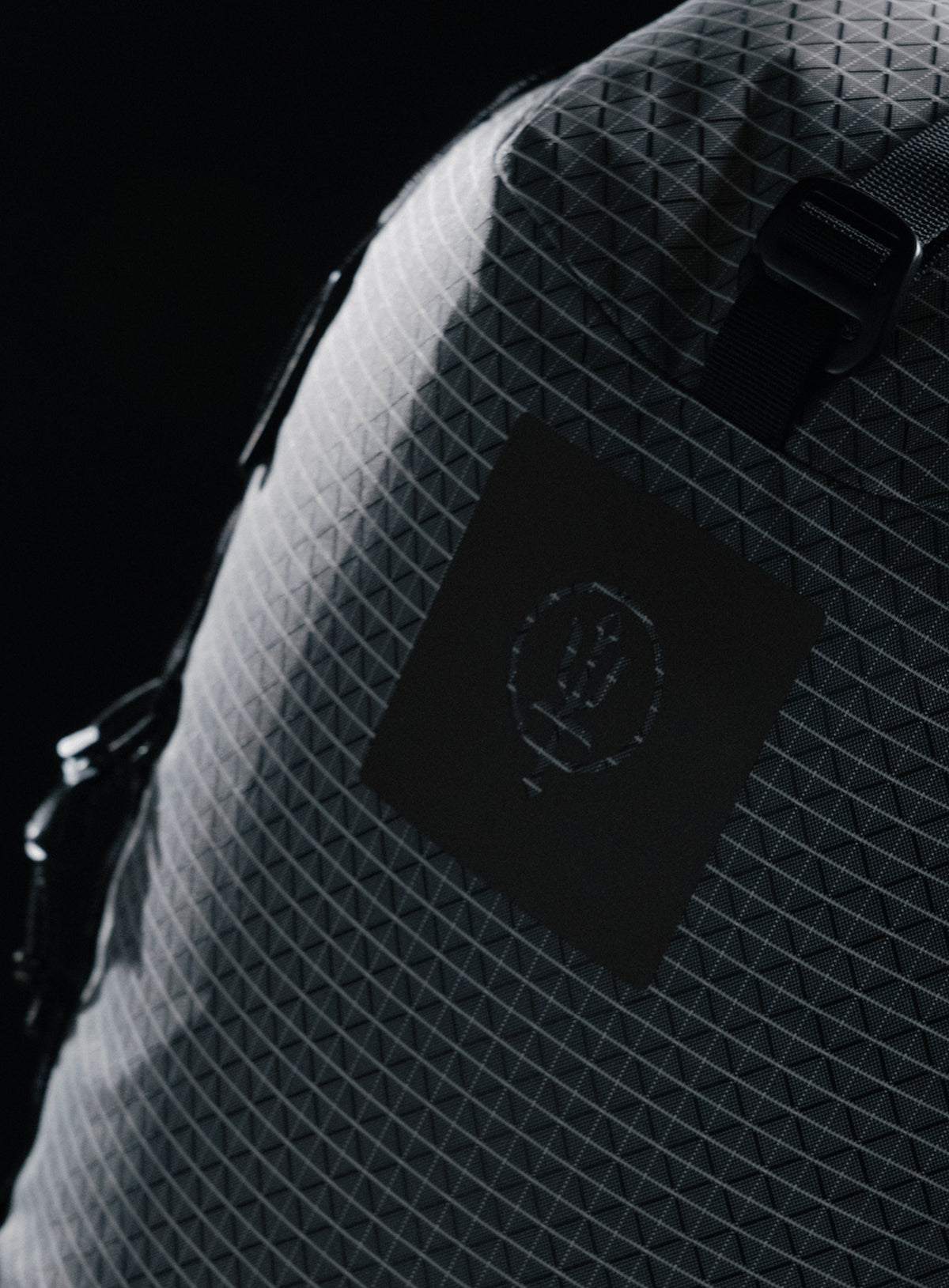 A creative studio shot of Orbital 30L Dyneema Climbing Backpack in Antimony Grey (CS)