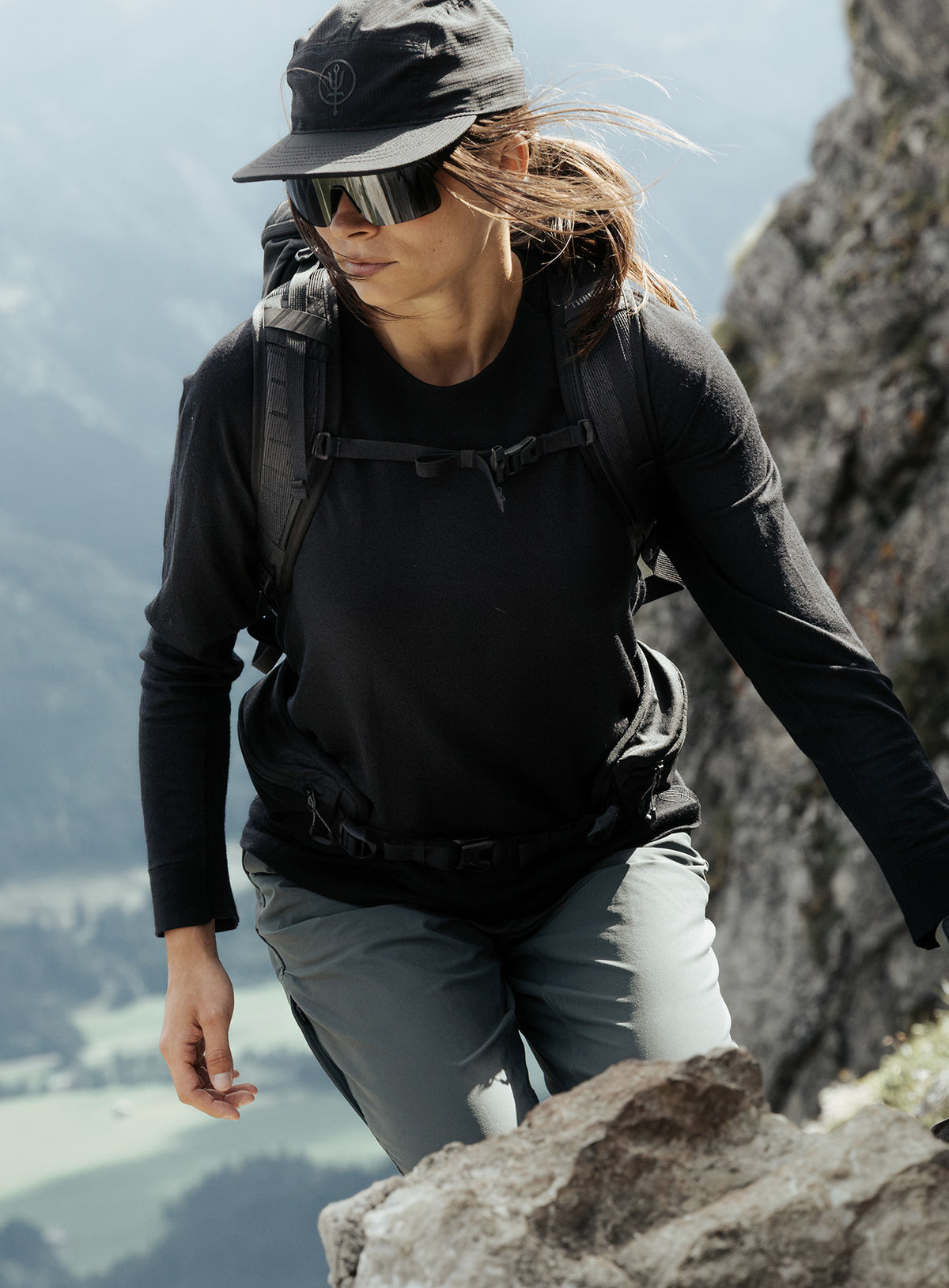 An in the field image of Women's Oryon 72HR Merino Long Sleeve T-Shirt in Obsidian Black (ITF)