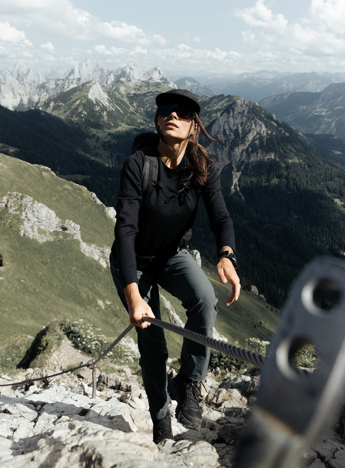 An in the field image of Women's Oryon 72HR Merino Long Sleeve T-Shirt in Obsidian Black (ITF)