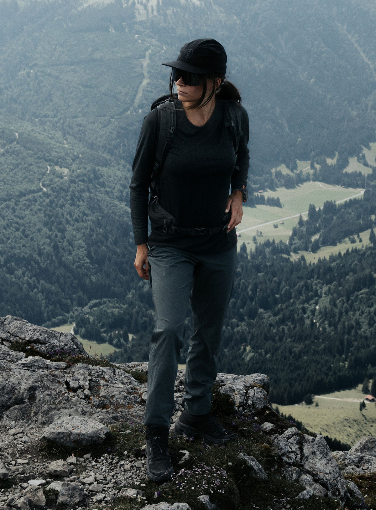 An in the field image of Women's Oryon 72HR Merino Long Sleeve T-Shirt in Obsidian Black (ITF)