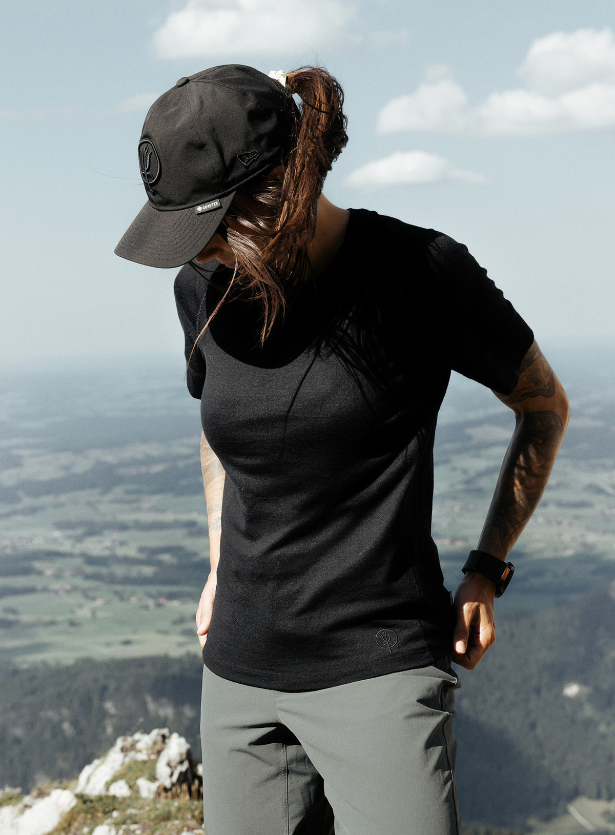 An in the field image of Women's Oryon 72HR Merino T-Shirt in Obsidian Black (ITF)