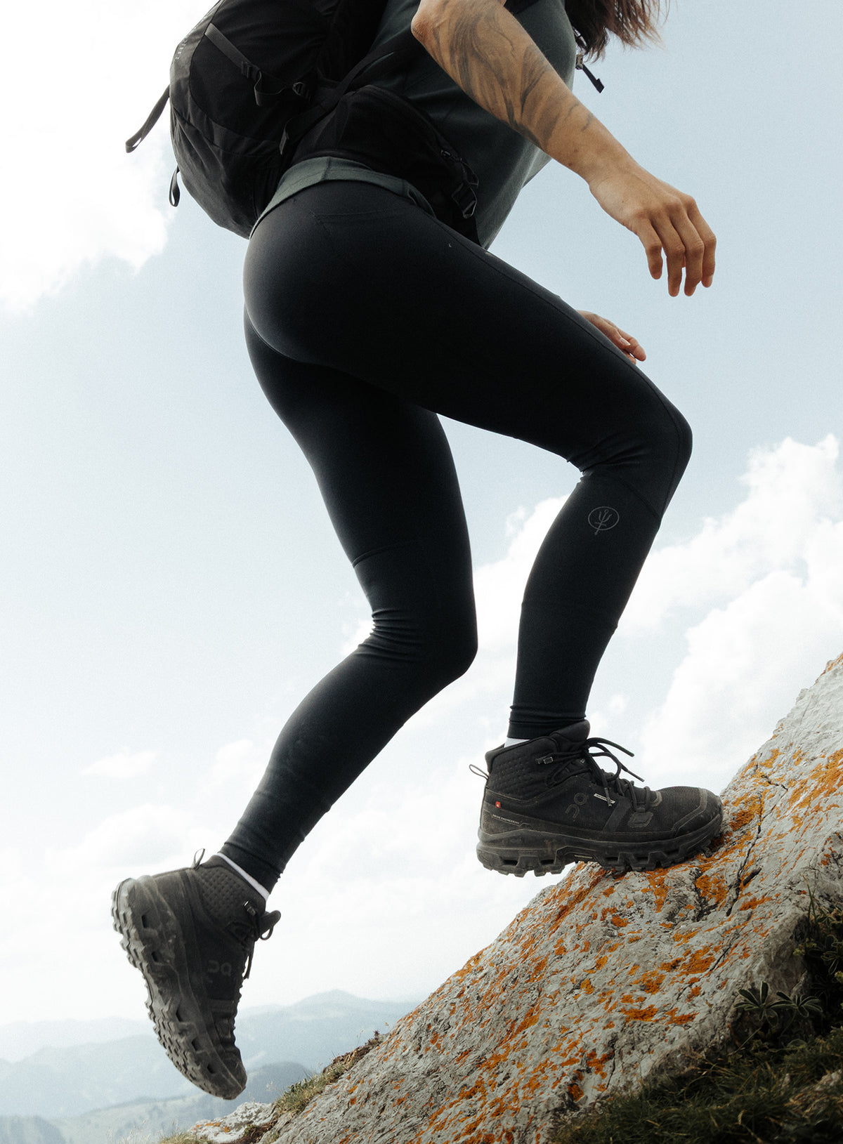 An in the field image of Women's Oryon Leggings in Obsidian Black (ITF)
