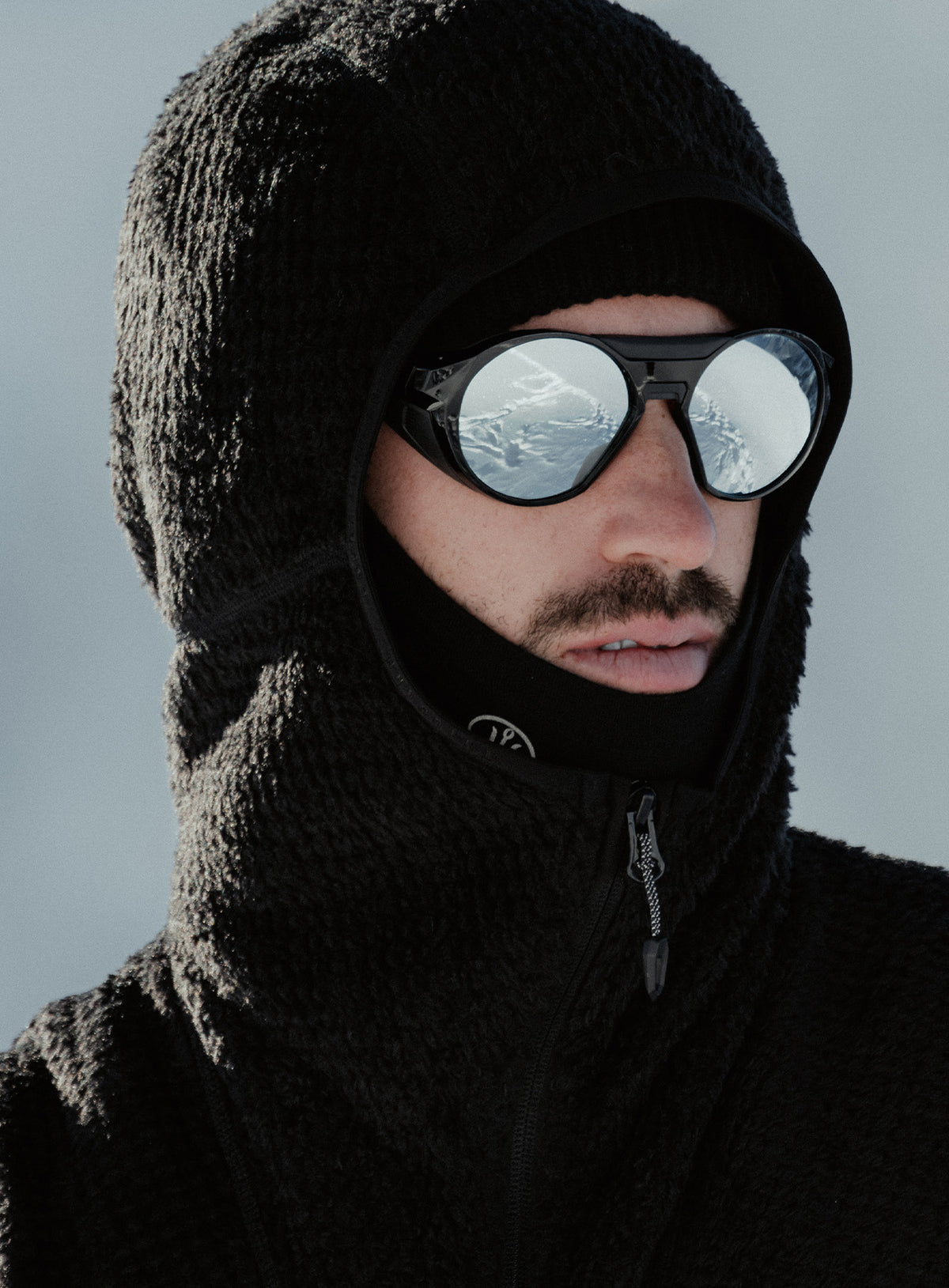 A creative studio shot of Phalanx Hooded Fleece in Obsidian Black (CS)