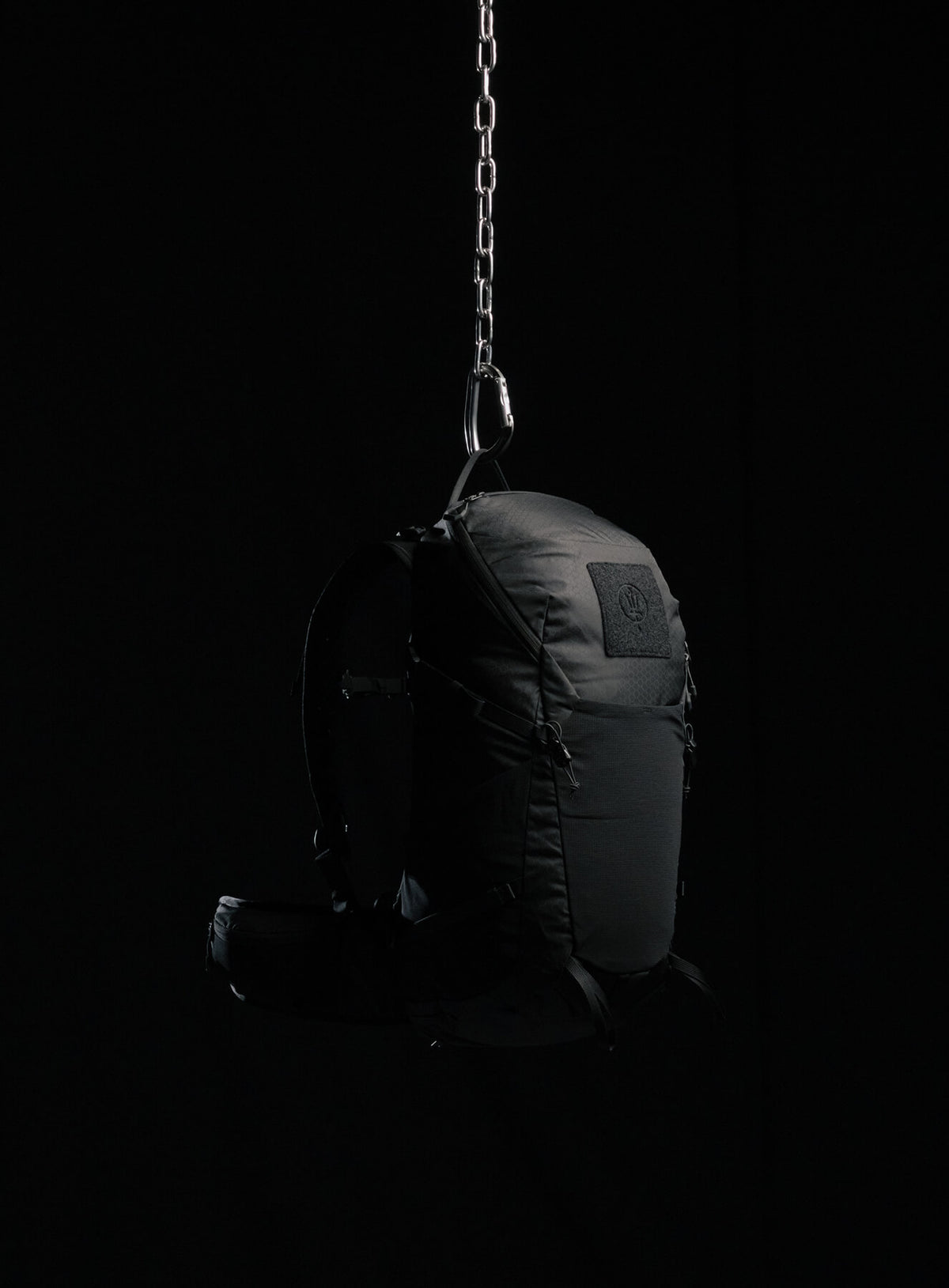A creative studio shot of Pinnacle 28L Hiking Backpack in Obsidian Black (CS)
