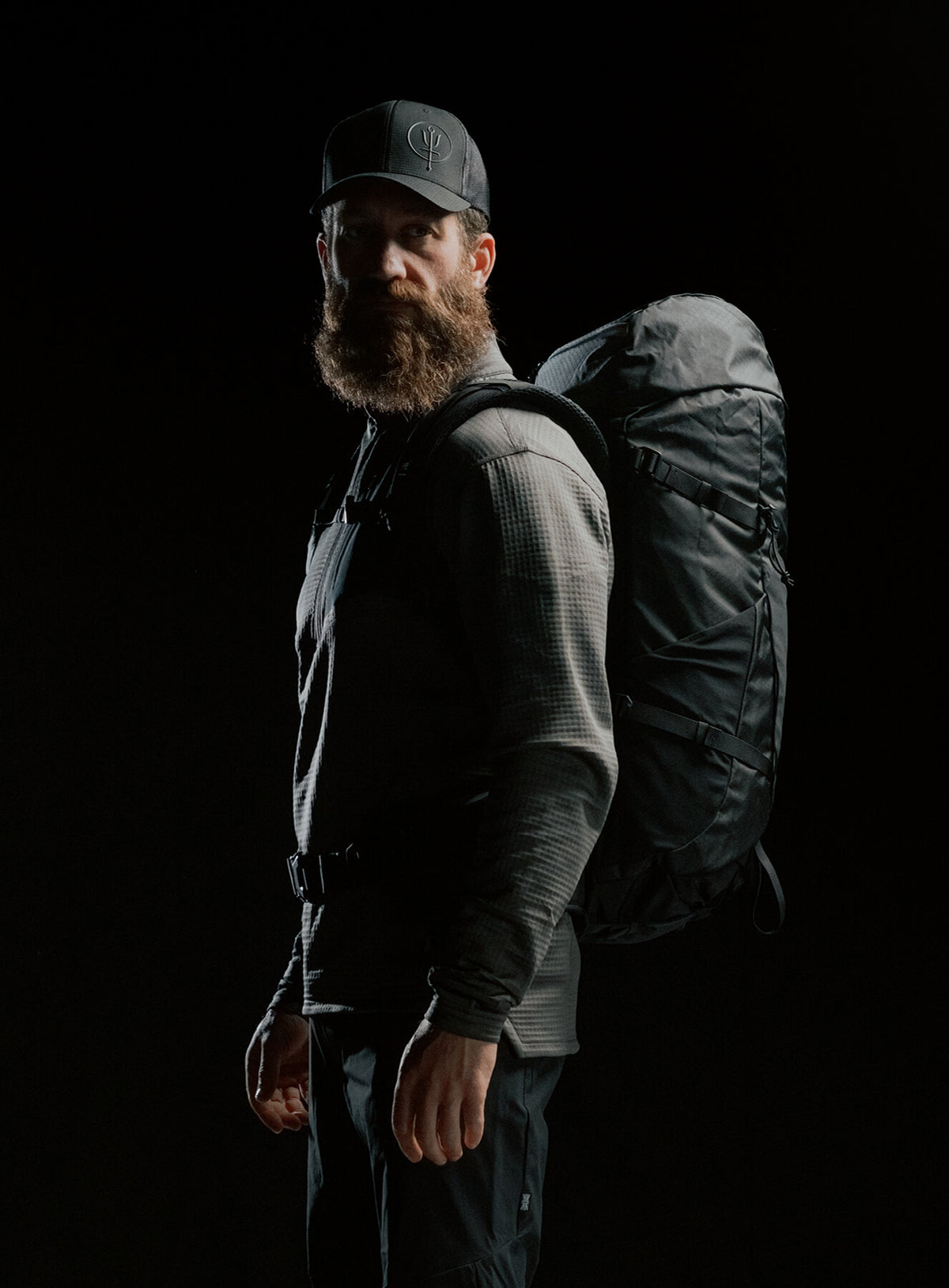 A creative studio shot of Pinnacle 42L Hiking Backpack in Obsidian Black (CS)