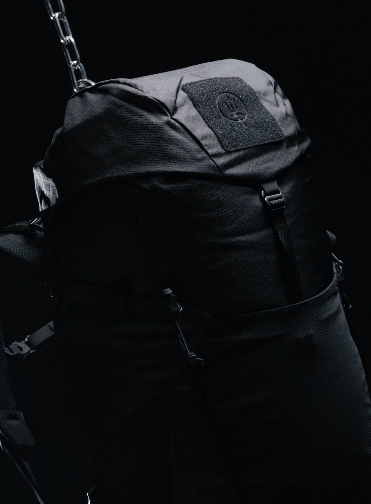 A creative studio shot of Pinnacle 42L Hiking Backpack in Obsidian Black (CS)