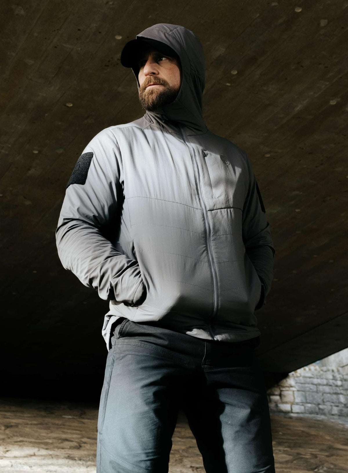 An in the field image of Men's Wraith Hooded Jacket in Raven Grey (ITF)